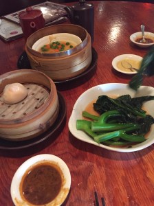 Clockwise, from top: an empty basket of shrimp balls, bok choy with oyster sauce, har gow (shrimp in rice dumplings).
